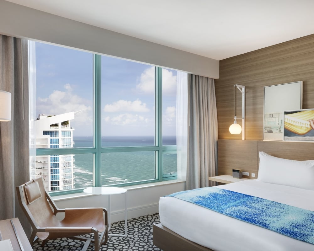 Diplomat Suite Bedroom with a view of the ocean from the bed