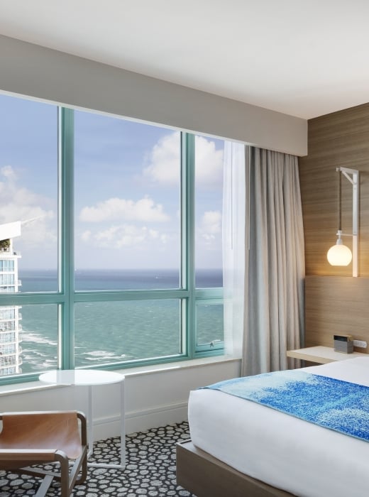 Diplomat Suite Bedroom with a view of the ocean from the bed