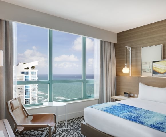 Diplomat Suite Bedroom with a view of the ocean from the bed