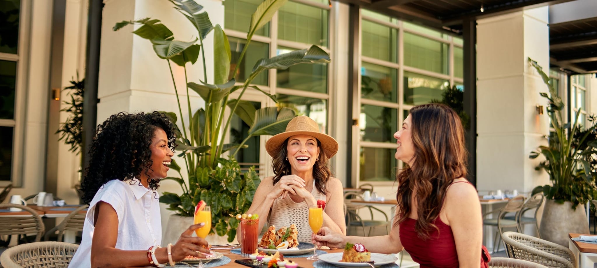 Three woman seated on an outdoor terrace for breakfast