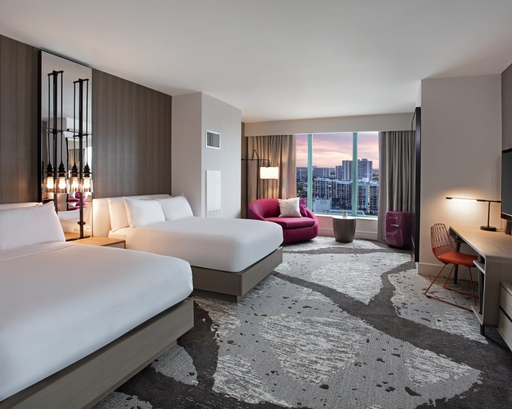 Deluxe Intracoastal Waterway Double Sunset accommodation with two queen beds, workspace, and large windows overlooking the city