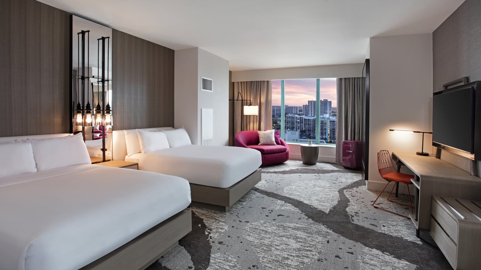 Deluxe Intracoastal Waterway Double Sunset accommodation with two queen beds, workspace, and large windows overlooking the city