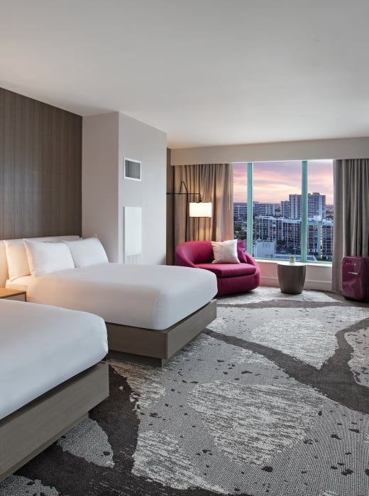 Deluxe Intracoastal Waterway Double Sunset accommodation with two queen beds, workspace, and large windows overlooking the city