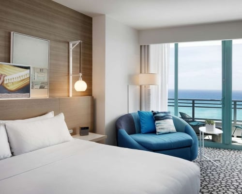 Grand King Oceanfront Bedroom with views of the outdoor patio and ocean beyond