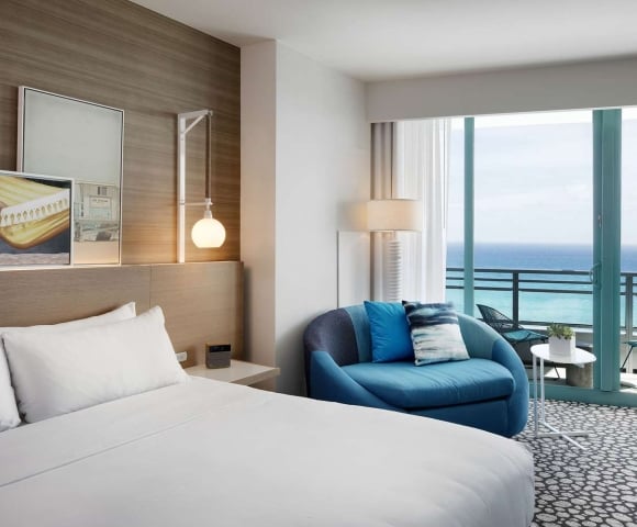Grand King Oceanfront Bedroom with views of the outdoor patio and ocean beyond