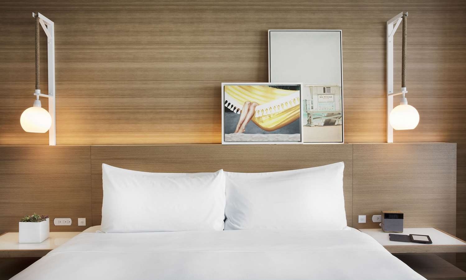 Sunrise King accommodation at The Diplomat, featuring hanging pendant lights and modern wall art