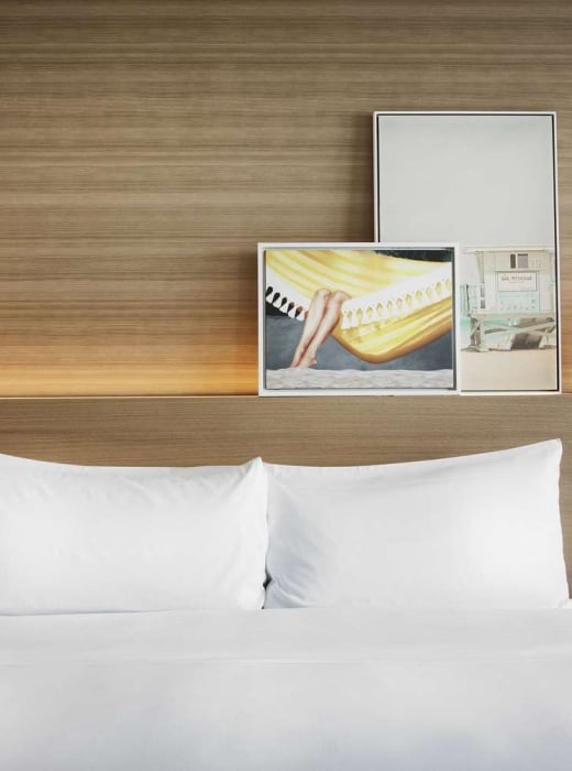 Sunrise King accommodation at The Diplomat, featuring hanging pendant lights and modern wall art