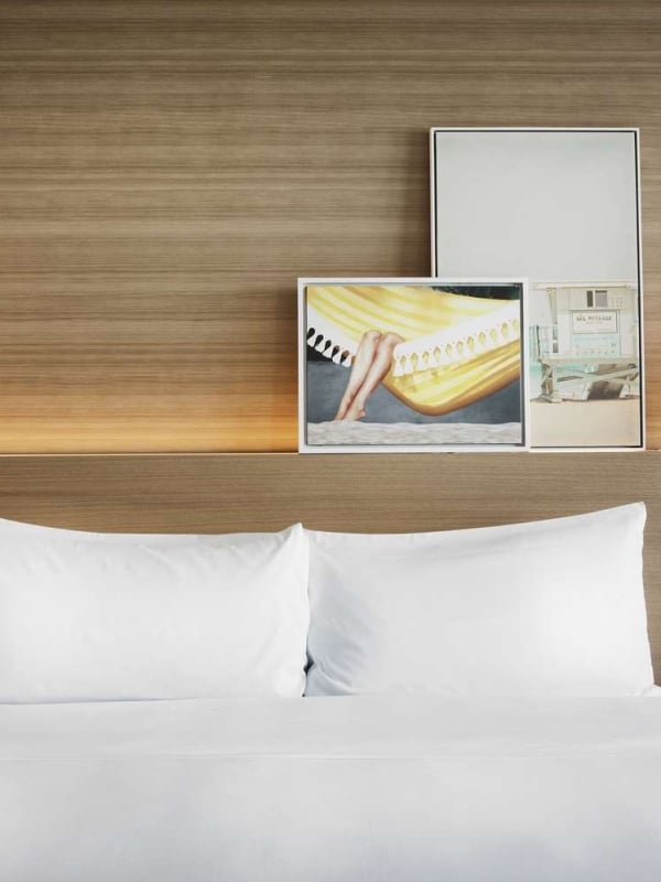 Sunrise King accommodation at The Diplomat, featuring hanging pendant lights and modern wall art