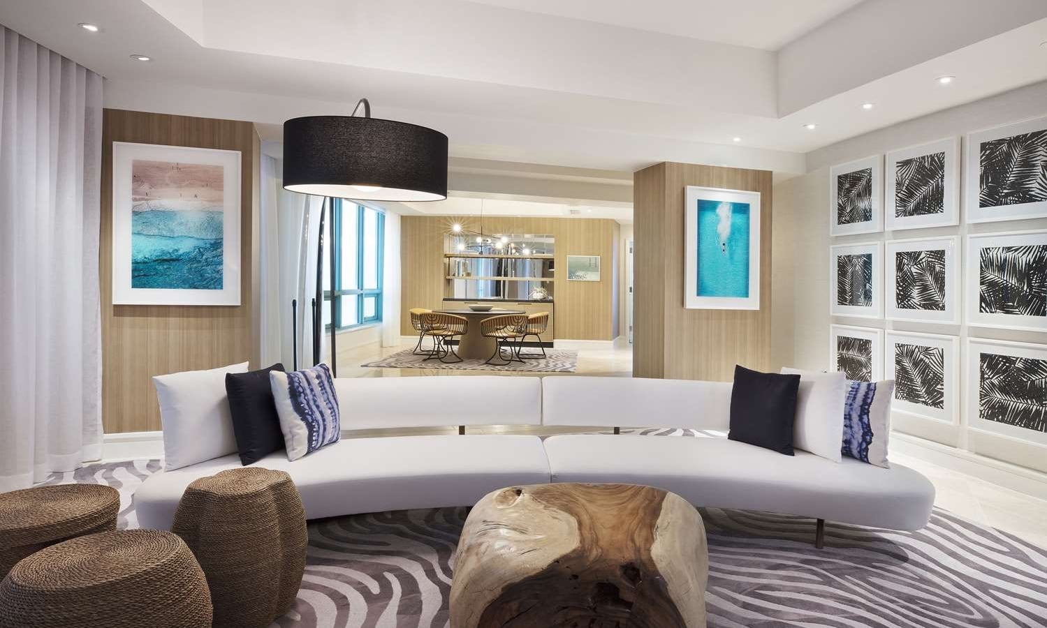Presidential suite at The Diplomat Resort featuring a stylish living room with modern sofa, fauna oriented wall decor, and an overall relaxing ocean vibe
