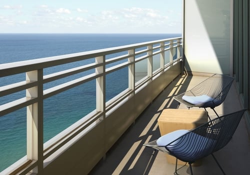 Oceanfront room patio overlooking the ocean with clear blue skies