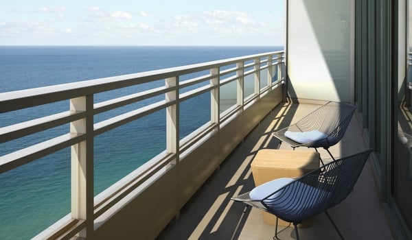 Oceanfront room patio overlooking the ocean with clear blue skies