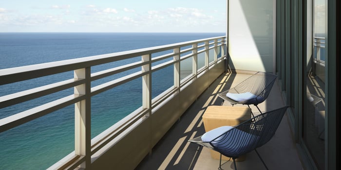 Oceanfront room patio overlooking the ocean with clear blue skies