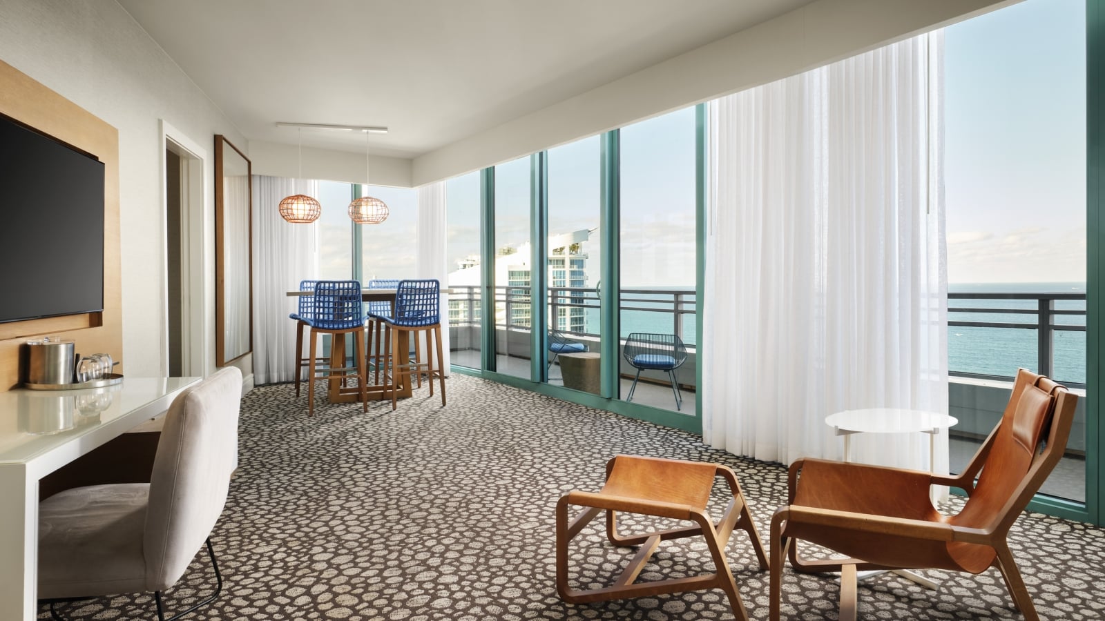 Oceanfront King Suite with floor to ceiling windows overlooking the patio and ocean beyond