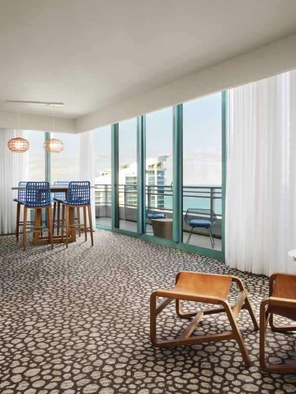 Oceanfront King Suite with floor to ceiling windows overlooking the patio and ocean beyond