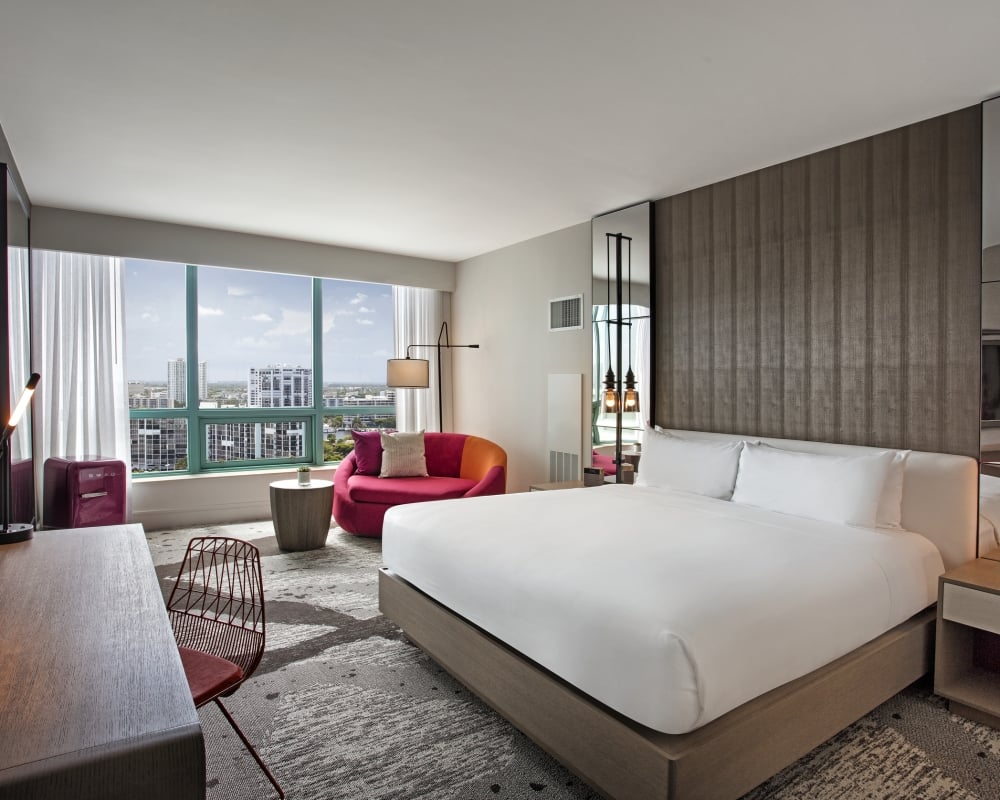 King Bed Intracoastal Guestroom with large windows overlooking the city