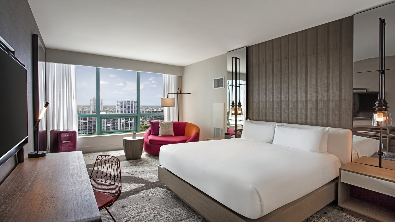 King Bed Intracoastal Guestroom with large windows overlooking the city