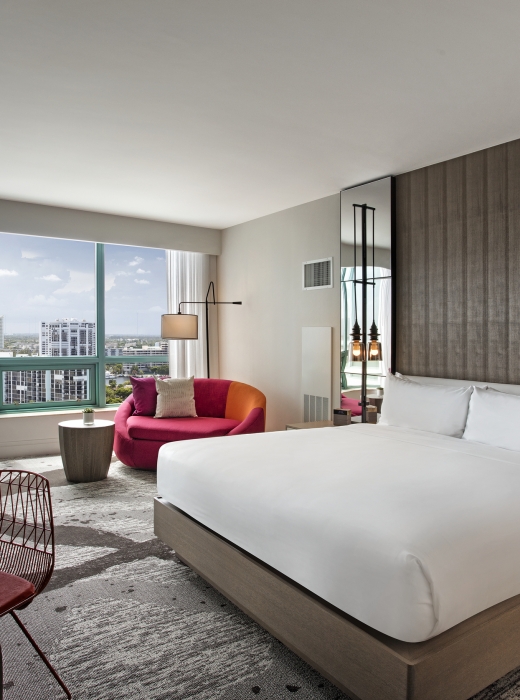 King Bed Intracoastal Guestroom with large windows overlooking the city