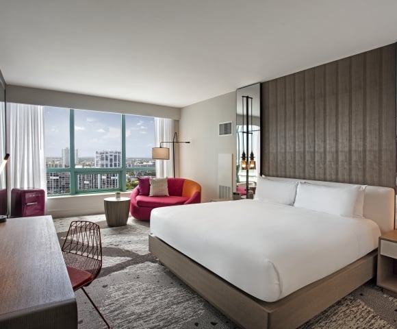 King Bed Intracoastal Guestroom with large windows overlooking the city